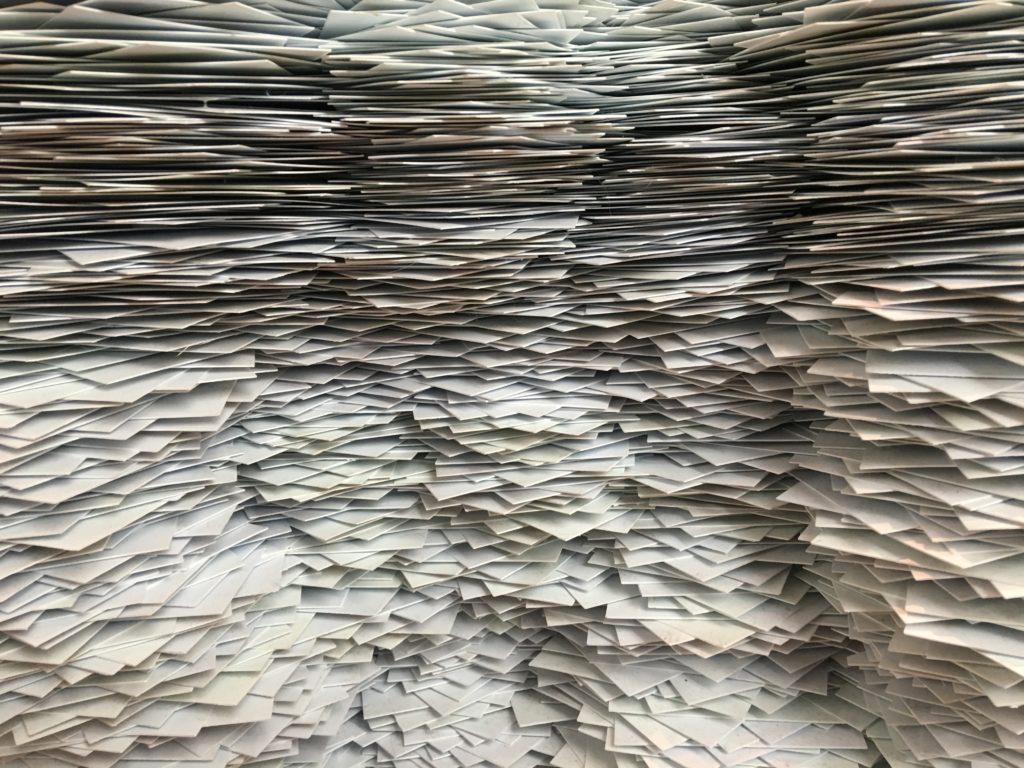 Photo of piles of paper or records.
