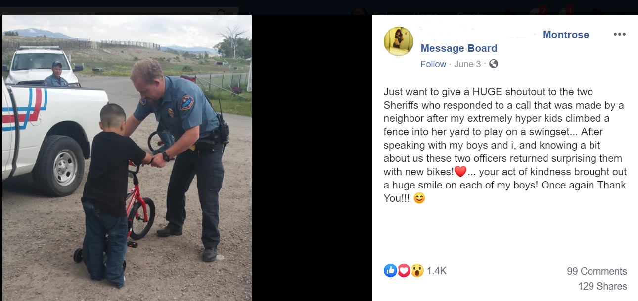 Photo of Deputy Giving a Bike to a Child
